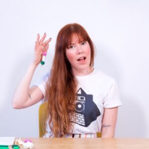 brittany bly holding finished diy clay bead keychain small square